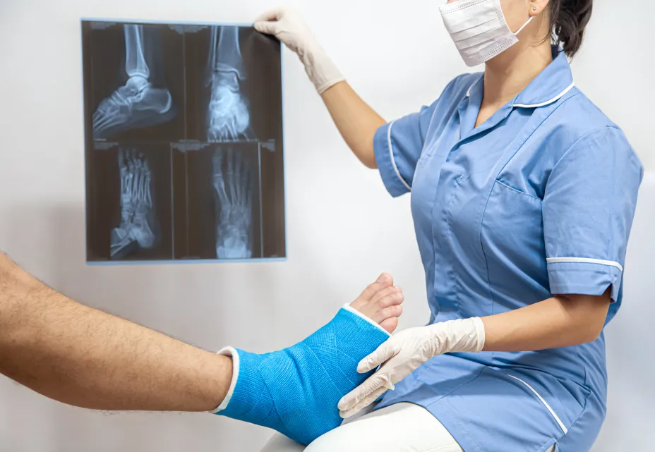 Doctor examining a foot injury with an X-ray for a hairline fracture.